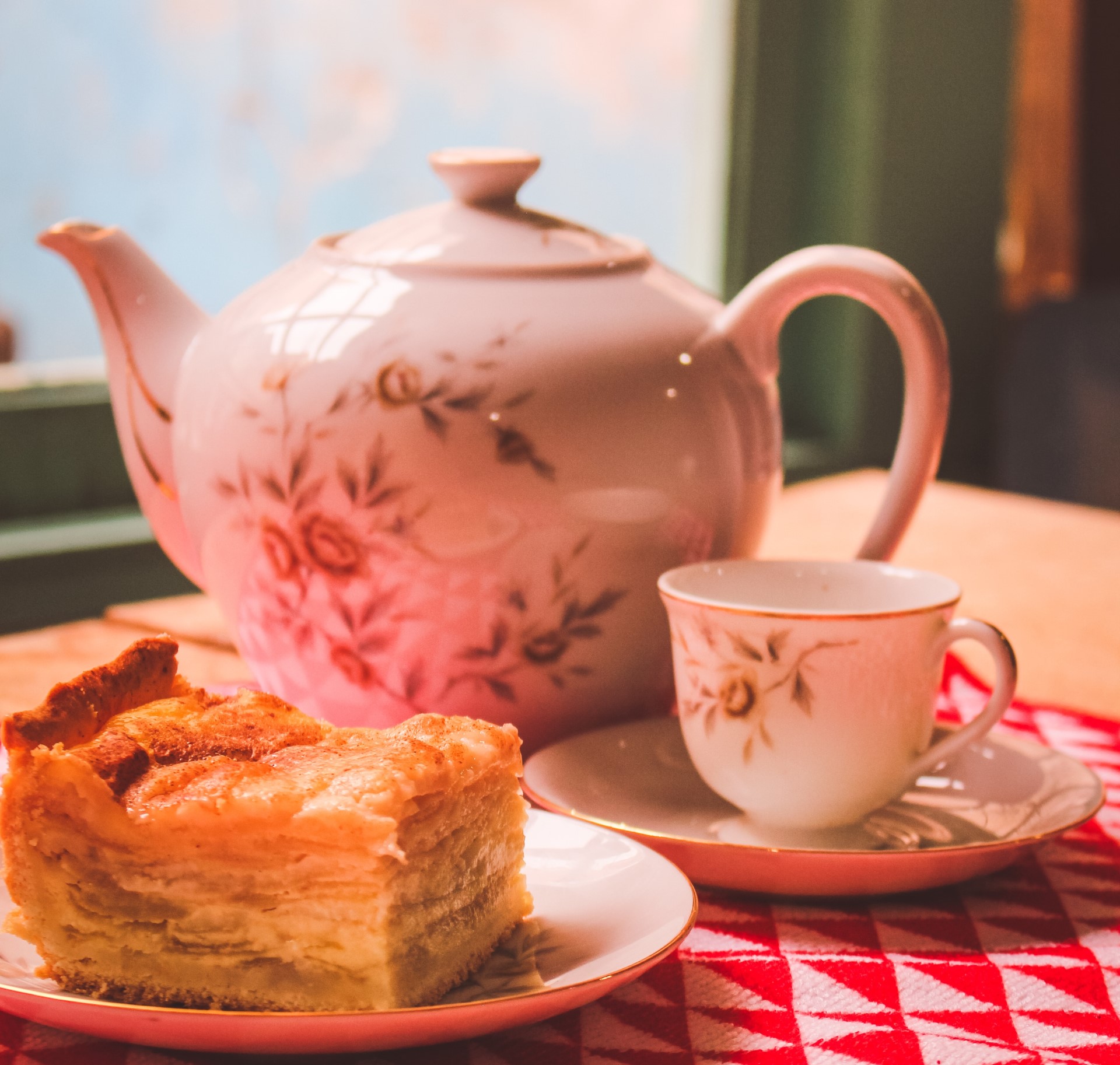 Teapot, cake and tea on a table.