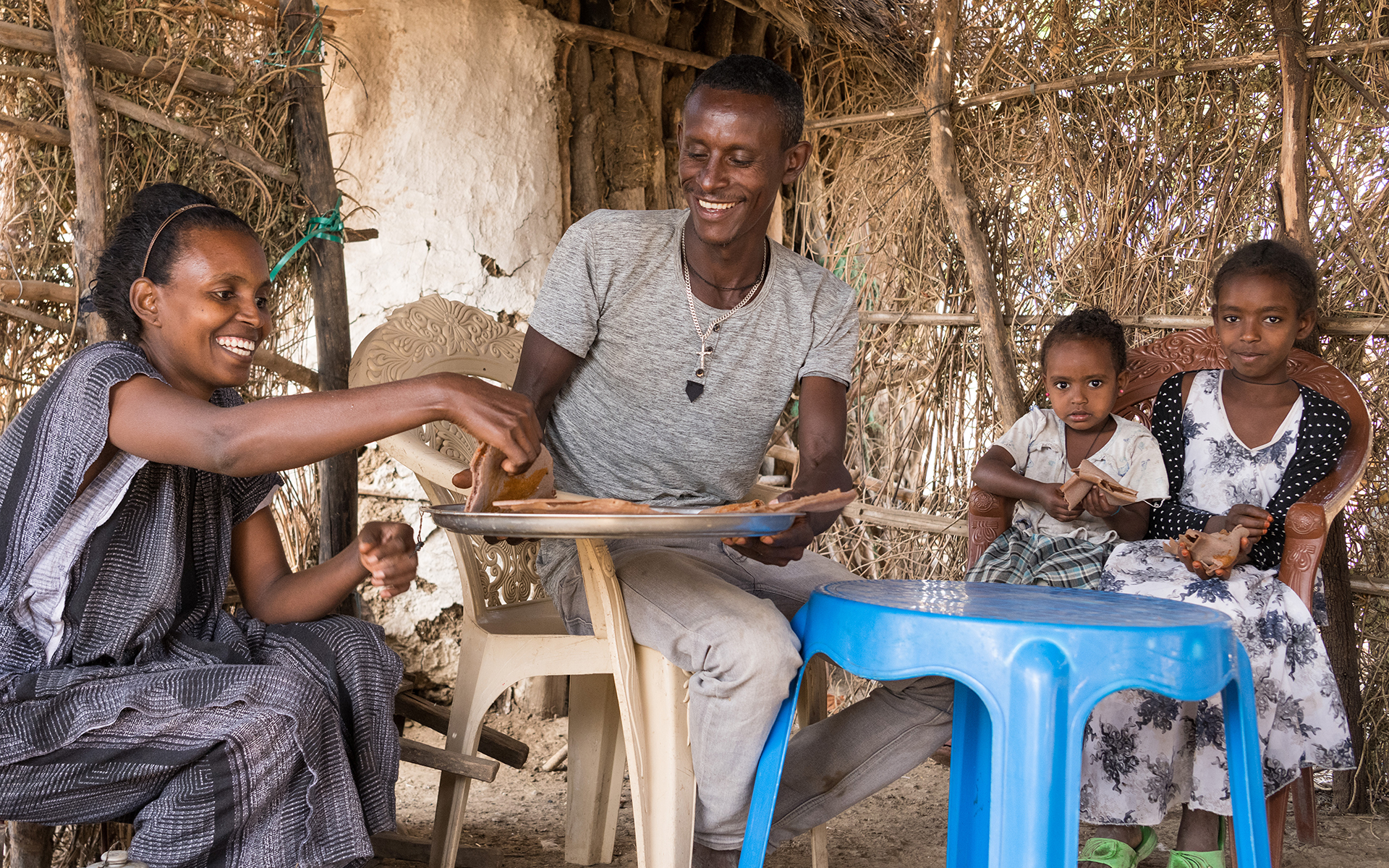Solomon Eating Injera With His Wife And Two Children In Their Home