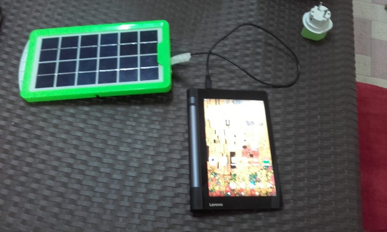 A RHoMIS tablet being charged by solar power