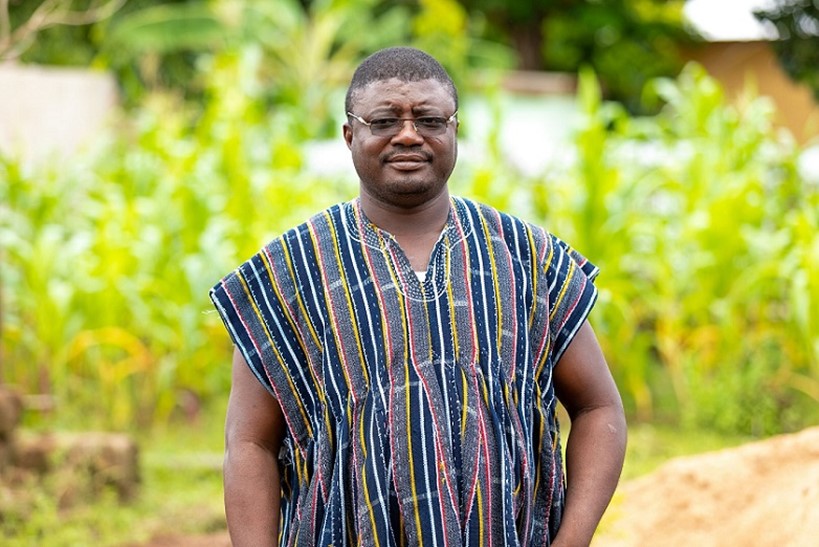 Jonathan Naaba standing in front of trees, smiling