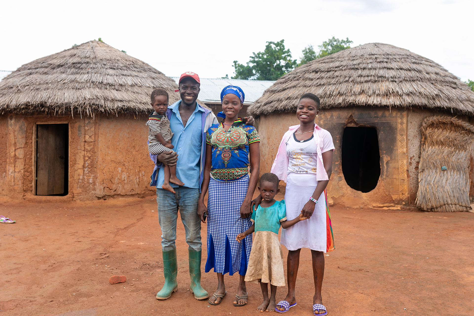 Francis, a man we are working with in Ghana, with his family in their home.