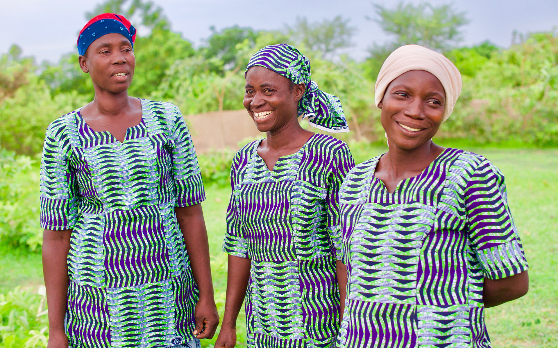 Women in a shea enterprise group smiling and laughing.