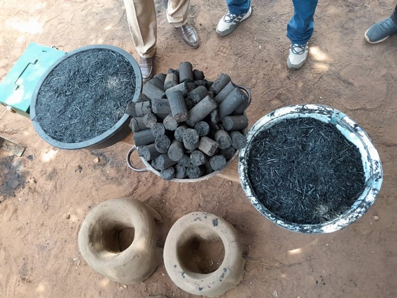 A bowl of grass briquettes on the ground