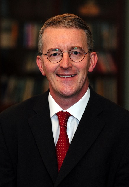 Headshot of Hilary Benn, Tree Aid Patron with bookcase behind